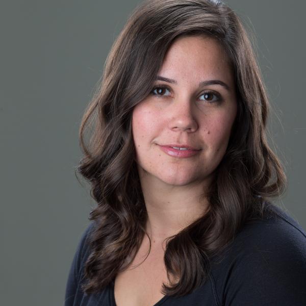 headshot of a white middle aged woman with long brown hair wearing a black shirt